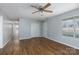 Spacious living room with wood flooring, a ceiling fan, a window with blinds, and a closet at 3507 Sassafras Trl, Waxhaw, NC 28173