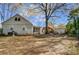 Large backyard showing the house, a shed, and a fire pit area, ideal for various activities at 3800 Craig Ave, Charlotte, NC 28211