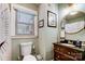 Updated bathroom features a vessel sink, dark wood vanity, and plenty of natural light at 3800 Craig Ave, Charlotte, NC 28211