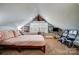 Sloped ceiling bedroom offering a large window, two chairs, and warm, comfortable carpeting at 3800 Craig Ave, Charlotte, NC 28211