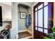 Functional entryway featuring decorative shelves, a coat rack, and a striking glass paneled door at 3800 Craig Ave, Charlotte, NC 28211