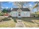 Charming cottage-style home with unique blue shutters and a well-maintained front yard at 3800 Craig Ave, Charlotte, NC 28211