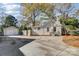 Home exterior with a detached garage, concrete driveway, and mature trees offering shade at 3800 Craig Ave, Charlotte, NC 28211