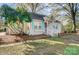 Charming bungalow with painted brick, a cozy front porch, and delightful, light-colored, mint-green shutters at 3800 Craig Ave, Charlotte, NC 28211