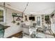 Cozy sunroom features a glass table, comfortable seating, painted brick, and decorative wall decor at 3800 Craig Ave, Charlotte, NC 28211