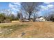 Expansive backyard with fenced perimeter and ample space for outdoor activities, set against a backdrop of mature trees at 400 37Th Sw St, Hickory, NC 28602