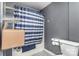Compact bathroom with a shower/tub combo featuring a blue and white shower curtain at 400 37Th Sw St, Hickory, NC 28602