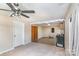 Spacious room with carpeted and hardwood flooring, fan, and natural light near kitchen and closet at 400 37Th Sw St, Hickory, NC 28602