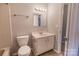 Bright bathroom with a classic vanity, updated light fixture, and tiled flooring at 4814 Spring Lake E Dr, Charlotte, NC 28212