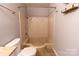 Bathroom featuring a ceramic tiled shower and a standard toilet at 4814 Spring Lake E Dr, Charlotte, NC 28212