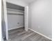 Bedroom featuring an open closet with shelving and vinyl floors at 4814 Spring Lake E Dr, Charlotte, NC 28212