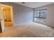 Bright bedroom with a large window and plush carpeting at 4814 Spring Lake E Dr, Charlotte, NC 28212