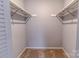 Spacious walk-in closet with carpeted floor and rod-and-shelf system for optimal storage at 4814 Spring Lake E Dr, Charlotte, NC 28212