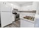 Well-lit kitchen with white cabinets, stainless steel appliances and laminate countertops at 4814 Spring Lake E Dr, Charlotte, NC 28212