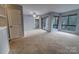 Spacious living room features a sliding glass door to the balcony and a ceiling fan at 4814 Spring Lake E Dr, Charlotte, NC 28212