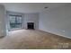 Comfortable living room with a fireplace and large windows for natural light at 4814 Spring Lake E Dr, Charlotte, NC 28212