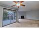 Bright living room featuring a fireplace and sliding door access to balcony at 4814 Spring Lake E Dr, Charlotte, NC 28212