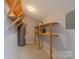 Unfinished storage area with shelving and open rafters at 4814 Spring Lake E Dr, Charlotte, NC 28212