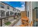Modern balcony with outdoor seating and a view of the neighboring townhome community at 521 Annie Lowery Way, Davidson, NC 28036
