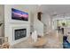 View of the living room with fireplace, staircase, and entrance to the kitchen at 521 Annie Lowery Way, Davidson, NC 28036