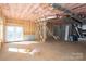 Unfinished basement space with exposed insulation, concrete walls, and a walkout door at 527 Crowell Ave, Statesville, NC 28677