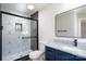 Updated bathroom with modern shower, stylish tile, black hardware, and vanity with granite countertop at 527 Crowell Ave, Statesville, NC 28677