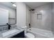 Bathroom featuring gray tile, black hardware, and a tub with shower at 527 Crowell Ave, Statesville, NC 28677