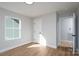 Bright, empty bedroom with hardwood floors, white trim, and a door to hallway at 527 Crowell Ave, Statesville, NC 28677