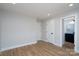 Bedroom features sleek wood floors and a doorway leading to an attached bathroom at 527 Crowell Ave, Statesville, NC 28677
