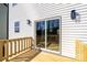 New wooden deck with white railing and siding, featuring a sliding glass door and modern lighting at 527 Crowell Ave, Statesville, NC 28677