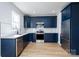 Modern kitchen featuring navy cabinets, stainless steel appliances, and granite countertops at 527 Crowell Ave, Statesville, NC 28677
