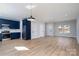 Open-concept living space featuring sleek wood floors, stylish blue kitchen, and ample natural light at 527 Crowell Ave, Statesville, NC 28677