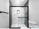 Modern shower with stylish geometric tile, black hardware, and glass doors at 527 Crowell Ave, Statesville, NC 28677