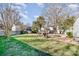 Expansive backyard with a mix of grass, trees, and other greenery, offering a serene and private outdoor space at 5304 Split Oak Dr, Charlotte, NC 28227