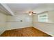 Finished basement space with wood-look floors, a window, and a ceiling fan at 5304 Split Oak Dr, Charlotte, NC 28227