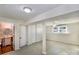 Bright basement featuring painted concrete floors, access to a full bathroom, storage, and natural light at 5304 Split Oak Dr, Charlotte, NC 28227