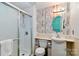 Cozy full bathroom with a wood accent wall, sink with cabinet, toilet, and sliding door shower stall at 5304 Split Oak Dr, Charlotte, NC 28227