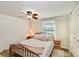 Cozy bedroom with a metal bed frame, ceiling fan, and wood-look floors at 5304 Split Oak Dr, Charlotte, NC 28227