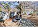 Outdoor fire pit area with stone pavers, chairs, and string lights, ideal for cozy gatherings at 5304 Split Oak Dr, Charlotte, NC 28227
