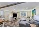 Spacious living room with a comfortable gray sectional, modern flooring, and natural light at 5304 Split Oak Dr, Charlotte, NC 28227