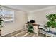 Bright home office featuring wood-look floors, a large window, and an inviting workspace at 5304 Split Oak Dr, Charlotte, NC 28227