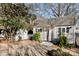 Charming shed with gray roof, white trim, flower boxes, and surrounding landscaping, adding functionality and charm at 5304 Split Oak Dr, Charlotte, NC 28227