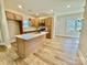 Modern kitchen with an island, stainless steel appliances, and wood-look flooring at 613 Granite Ave, Gastonia, NC 28052