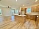 Modern kitchen with an island, stainless steel appliances, and wood-look flooring at 613 Granite Ave, Gastonia, NC 28052