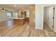Open-concept living area flowing into the kitchen, featuring stylish wood-look flooring at 613 Granite Ave, Gastonia, NC 28052