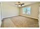 Neutral bedroom with carpet, ceiling fan and natural light from the large window at 620 Granite Ave, Gastonia, NC 28052