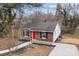 Aerial view of charming brick home with red front door and paved driveway at 621 E Sharpe St, Statesville, NC 28677