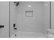 Modern bathroom featuring marble-style tile, new fixtures and a shower with recessed shelving at 621 E Sharpe St, Statesville, NC 28677