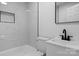 Modern bathroom featuring marble-style tile, new vanity and a shower with recessed shelving at 621 E Sharpe St, Statesville, NC 28677