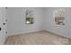 Freshly painted bedroom with new floors and a view of the outdoors from the dual windows at 621 E Sharpe St, Statesville, NC 28677